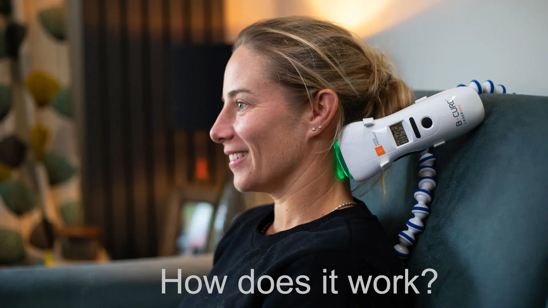 A woman is treating neck pain with B-Cure Laser